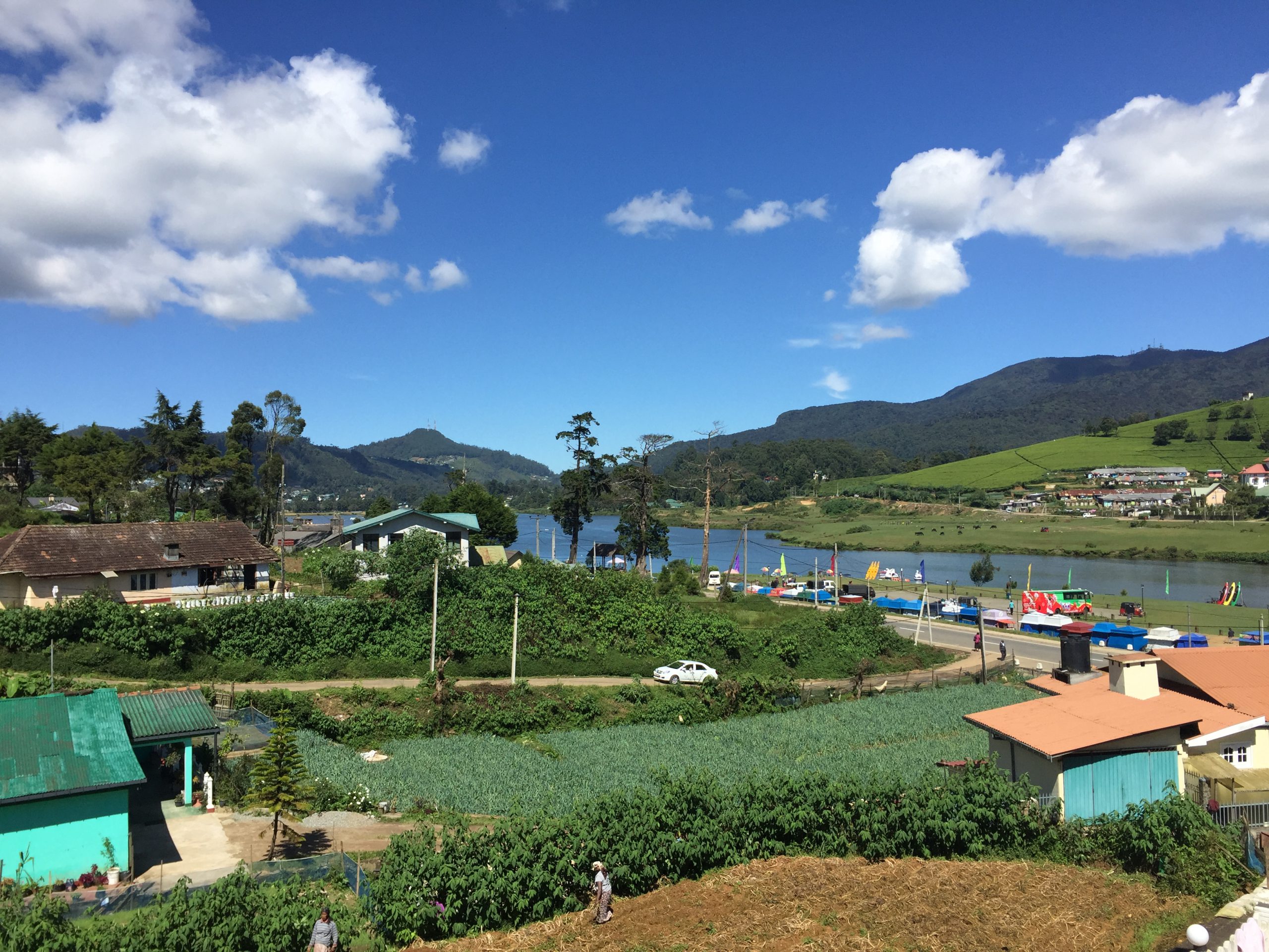 Elevated view of Lake Gregory, Nuwara Eliya buildings and green mountain slopes